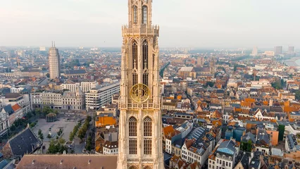 Plexiglas foto achterwand Antwerp, Belgium - July 21, 2023: Spire with the clock of the Cathedral of Our Lady (Antwerp). City Antwerp is located on river Scheldt (Escaut). Summer morning, Aerial View © nikitamaykov