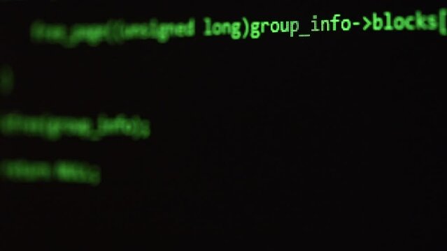 Close-up screen shot of a scrolling green programming code on a dark background.