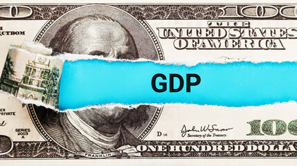 GDP (Gross Domestic Product). The word GDP in the background of the US dollar. National Economic...
