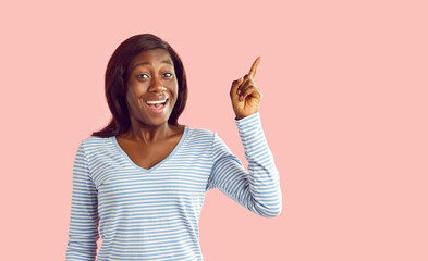 Portrait of a smiling excited young african american woman in casual clothes looking at the camera...
