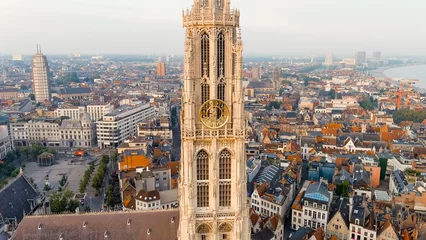 Abwaschbare Fototapete Antwerp, Belgium. Spire with the clock of the Cathedral of Our Lady (Antwerp). Historical center of Antwerp. City is located on river Scheldt (Escaut). Summer morning, Aerial View © nikitamaykov