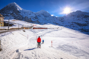 Fototapeta na wymiar Kleine Scheidegg ski area and Eigergletscher alpine railway to Jungrafujoch peak view
