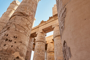 Famous ancient Karnak Temple complex, Luxor, Egypt. Ancient ruins of Karnak temple in Luxor. Egypt. Great Hypostyle Hall at the Temples of Karnak (ancient Thebes). - obrazy, fototapety, plakaty