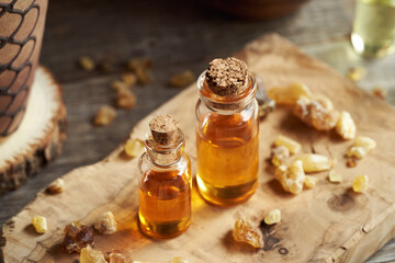 Two bottles of frankincense essential oil with boswellia resin