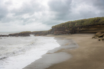 truman track beach in new zealand on rainy day
