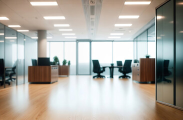 Blurred empty modern office. Defocused abstract light bokeh business open space interior background for design. Corporate strategy, finance, operations, marketing. Blur focus of tables with computers