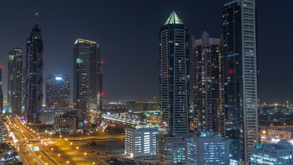 Business bay district skyline with modern architecture all night timelapse from above.