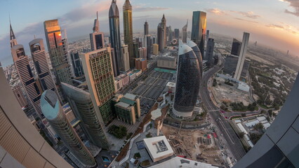 Skyline panorama of the high-rise buildings on Sheikh Zayed Road in Dubai aerial night to day timelapse, UAE.