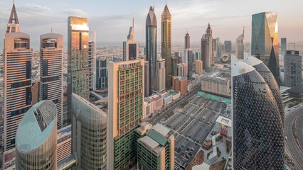 Skyline view of the high-rise buildings on Sheikh Zayed Road in Dubai aerial night to day timelapse, UAE.