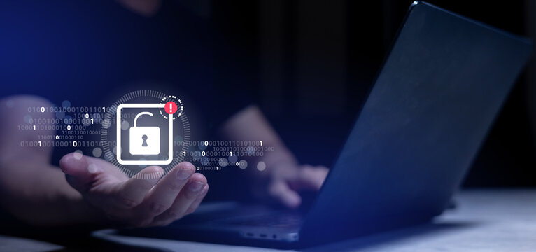 close up young man hand show unlocking icon of padlock with warning sign after security system fail by hacking binary code in the dark operation room for digital information and leakage data concept