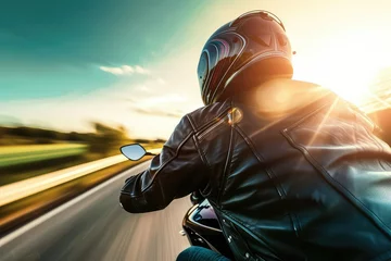 Abwaschbare Fototapete A motorcyclist speeds down the highway wearing a sleek crash helmet. © Suwanlee