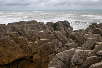 pancake rocks with sea in the background