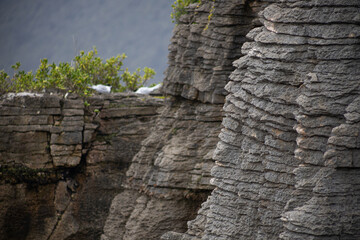 pancake rocks with seagulls on cloudy day