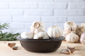 Bulbs and cloves of fresh garlic on wooden table
