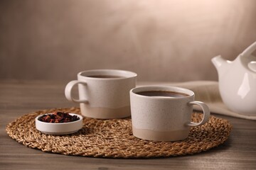 Aromatic tea and dry flower petals on wooden table