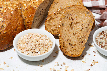 healthy bread with oats and seeds on white background, closeup