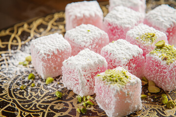 Delicate rosewater-infused Turkish delight, elegantly dusted with powdered sugar and pistachio crumbs, set against a backdrop of intricate arabesque p