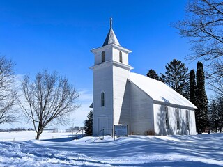 An old classic shaped country church out in the rural prairie
