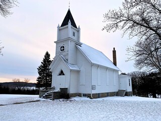 Sun setting over a bitter cold winter day with this old country church