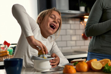  Laughter echoes in the kitchen as mother and daughters squeeze oranges, creating a refreshing...