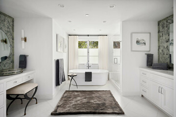 Spacious bathroom featuring a luxurious tub, elegant vanity, and two sinks