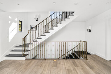 Wooden staircase with metal railing on top and bottom