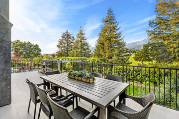 Deck with outdoor dining set overlooking scenic vineyard