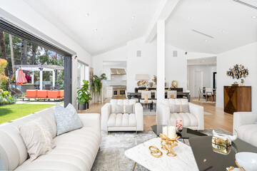 White couches and expansive windows offering scenic views in a stylish living room