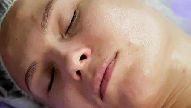 Hardware procedure in cosmetology. Close-up. Non-surgical facial skin lifting in a beauty clinic. A cosmetologist, a cosmetologist, moves a manipulator over the face. microcurrent treatment.