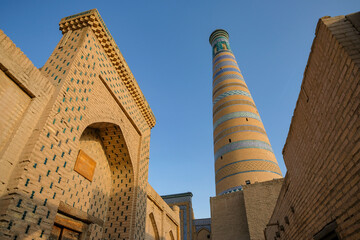 View of the minaret of the Islam Khodja madrasa in the old town of Khiva, Uzbekistan.