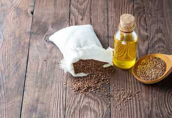 Flax seeds in a canvas bag and oil made from flax seeds in a bottle.