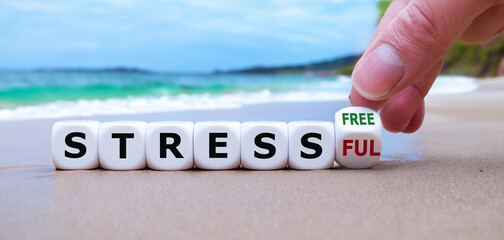 Hand turns dice and changes the expression 'stressful' to 'stress free'.