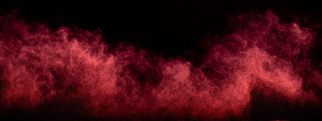 Red powder dust smoke on black background