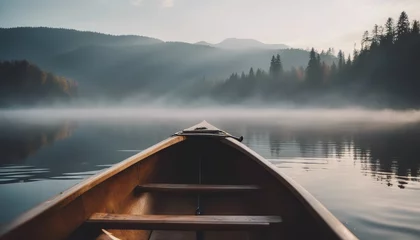 Foto op Plexiglas Bow of a canoe in the morning on a misty lake © Adi