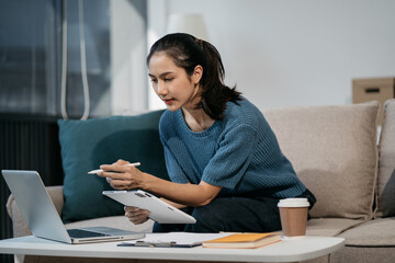 lifestyle of office workers Woman calculating expenses and using laptop. Home office. Work place....