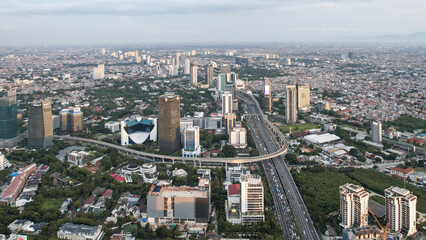 Naklejka premium Panoramic cityscape of Indonesia capital city Jakarta at sunset. A rare clear day in the polluted city.