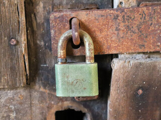 close up of the padlock locking the door. surabaya, indonesia - 4 january 2024