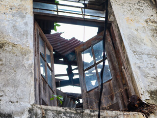 Fototapeta na wymiar a broken window of abandoned building. surabaya, indonesia - 4 january 2024