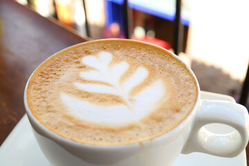 Closeup of frothy cappuccino coffee with beautiful latte art