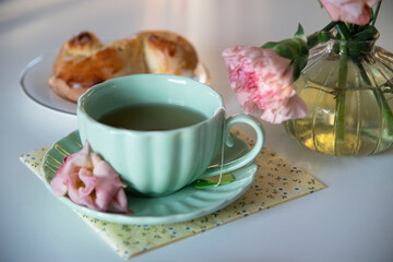 cup of tea and cookies on table