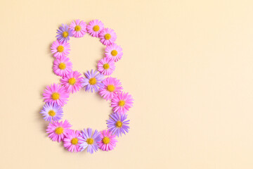 International Women's day, March 8th concept. Number eight 8 made of pink and purple asters flowers on beige background. Flower fonts, shape. Creative spring idea, stylish trendy greeting card.