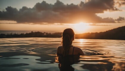 Fototapeta premium Portrait of woman in infinity pool in Bali, sunset view 