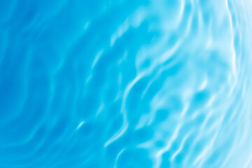 Blue water surface,Transparent blue clear water surface texture with ripples, splashes and bubbles. Abstract nature background Water waves in sunlight. Cosmetic moisturizer micellar toner emulsion. To