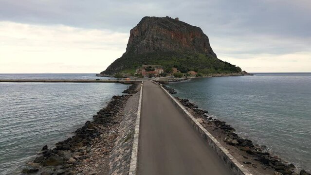Europe,Greece , Laconia - Monemvasia is a  tied island tourist attraction summer destination in  east coast of the Peloponnese - drone arial view of fortified city with walls by the sea