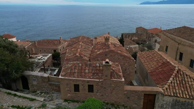 Europe,Greece , Laconia - Monemvasia is a  tied island tourist attraction summer destination in  east coast of the Peloponnese - drone arial view of fortified city with walls by the sea