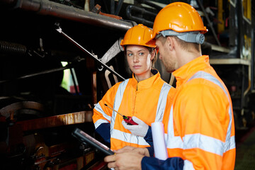 engineers or technicians working and checking construction train at station