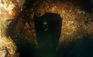 a diver exploring a shipwreck on the island of Curacao