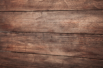 Fototapeta premium Vintage brown wood background texture with knots and nail holes. Old painted wood wall. Brown abstract background. Vintage wooden dark horizontal boards. Front view with copy space