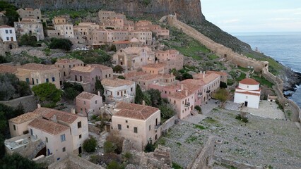 Fototapeta na wymiar Europe,Greece , Laconia - Monemvasia is a tied island tourist attraction summer destination in east coast of the Peloponnese - drone arial view of fortified city with walls by the sea