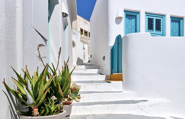 Light blue wooden door against clear white wall, Pyrgos Kallistis village, Santorini. Greek Islands, European Vacation.